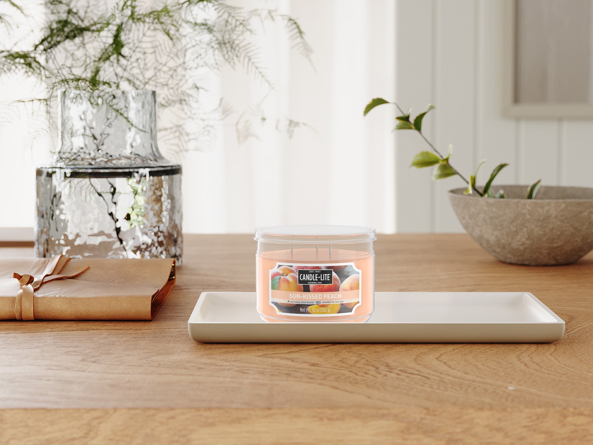 Candle on a wooden table with decorative items in the background