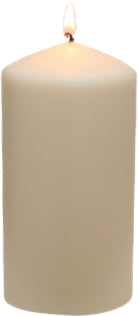 White pillar candle with a small flame