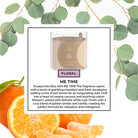 Candle labeled 'ME TIME' with floral description, surrounded by eucalyptus leaves and oranges.