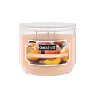 Candle-lite Sun-Kissed Peach candle in a clear container on a white background