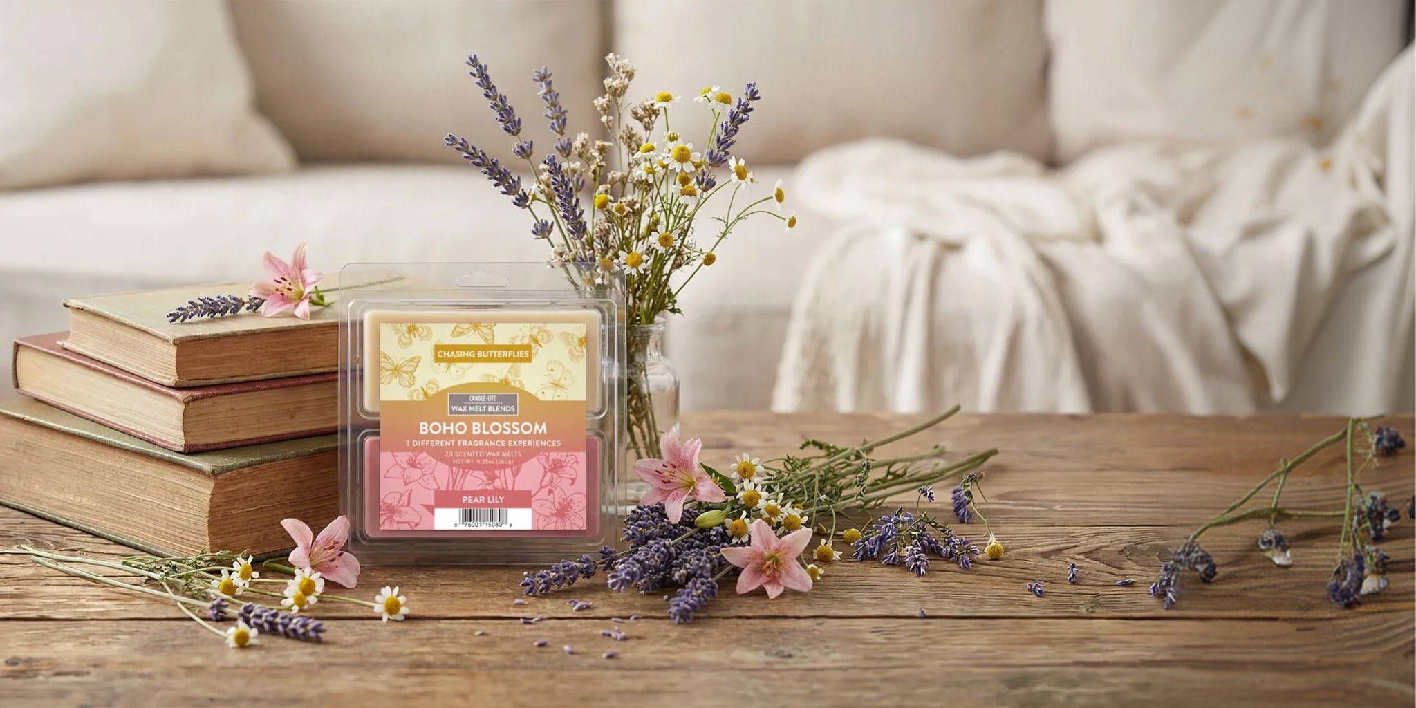 Boho Blossom wax melts on a table with floral sprigs.